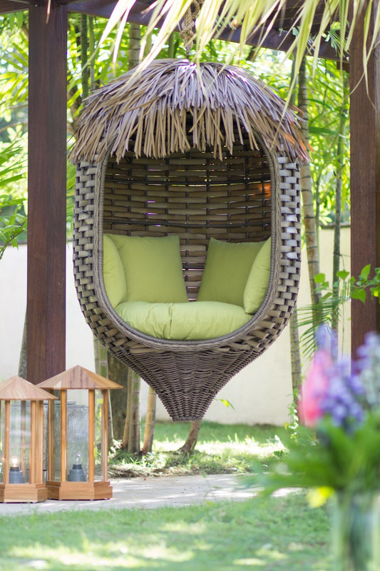 Boho rattan and grass fibre hanging chair Chania with green cushion, handmade in Bali
